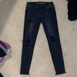 Womens low rise black ripped jean jeggings, frayed at the bottoms, new condition
